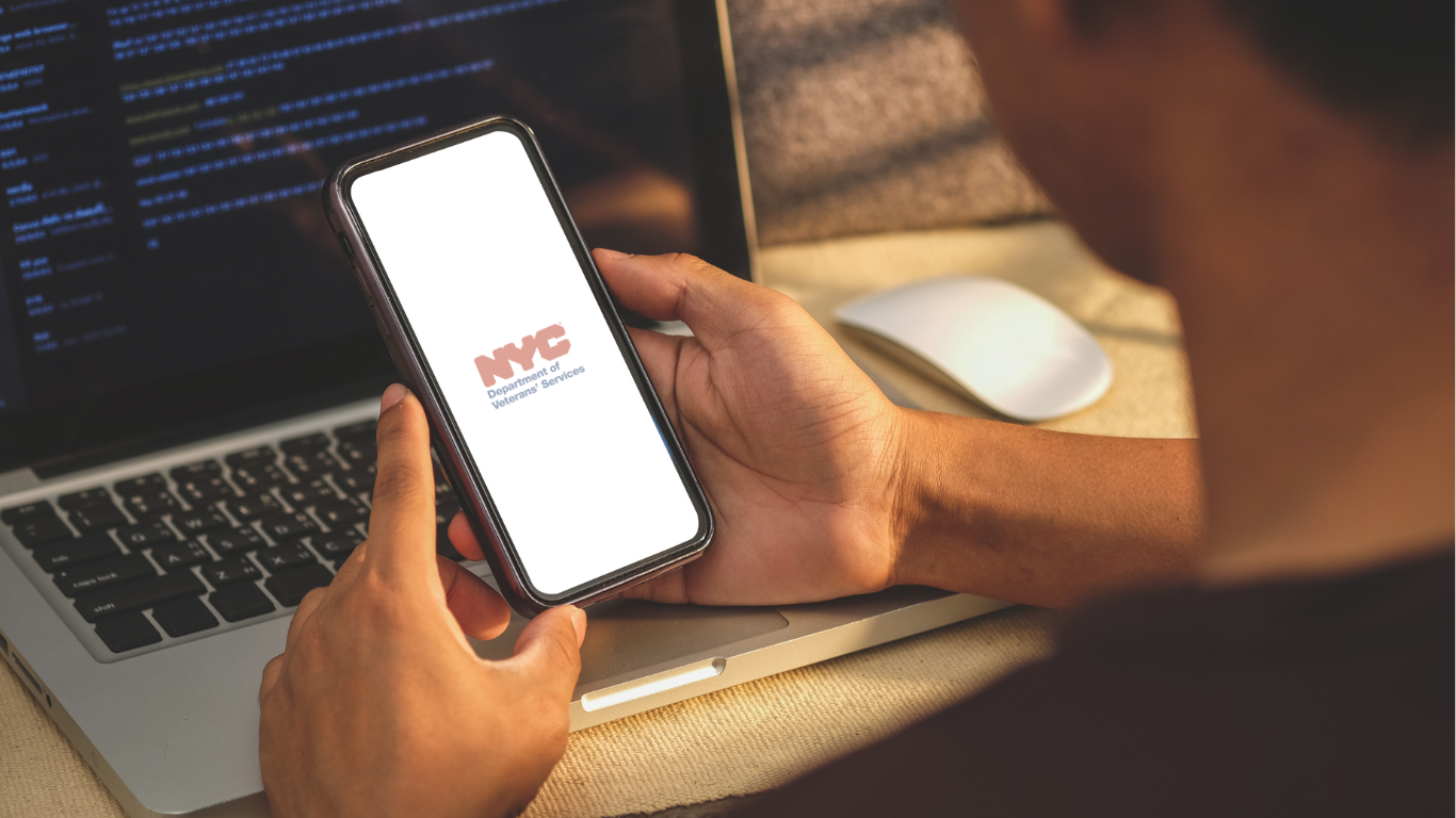 Volunteer holding phone with NYC Department of Veteran Services logo