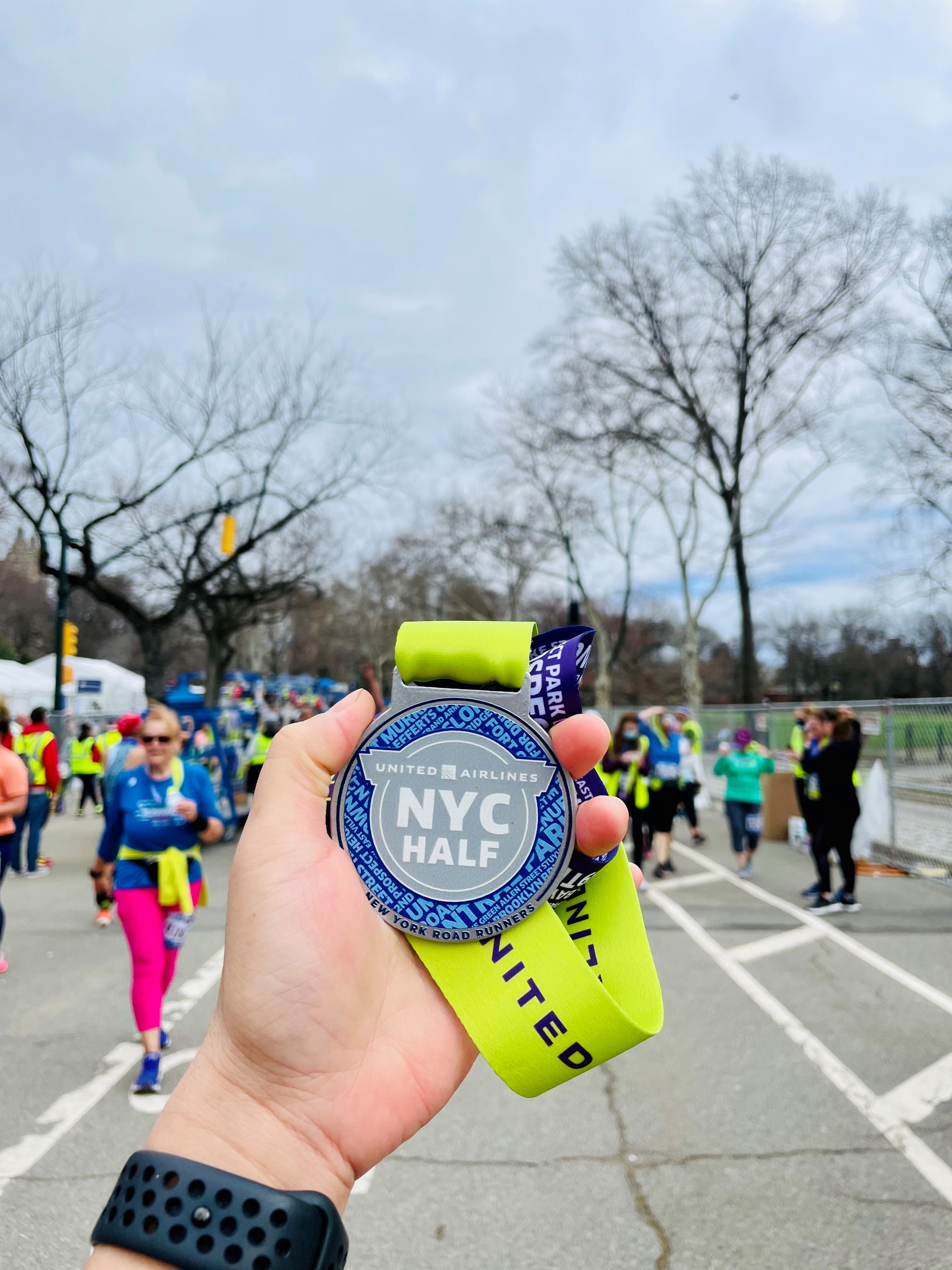 Runner holding United NYC half medal