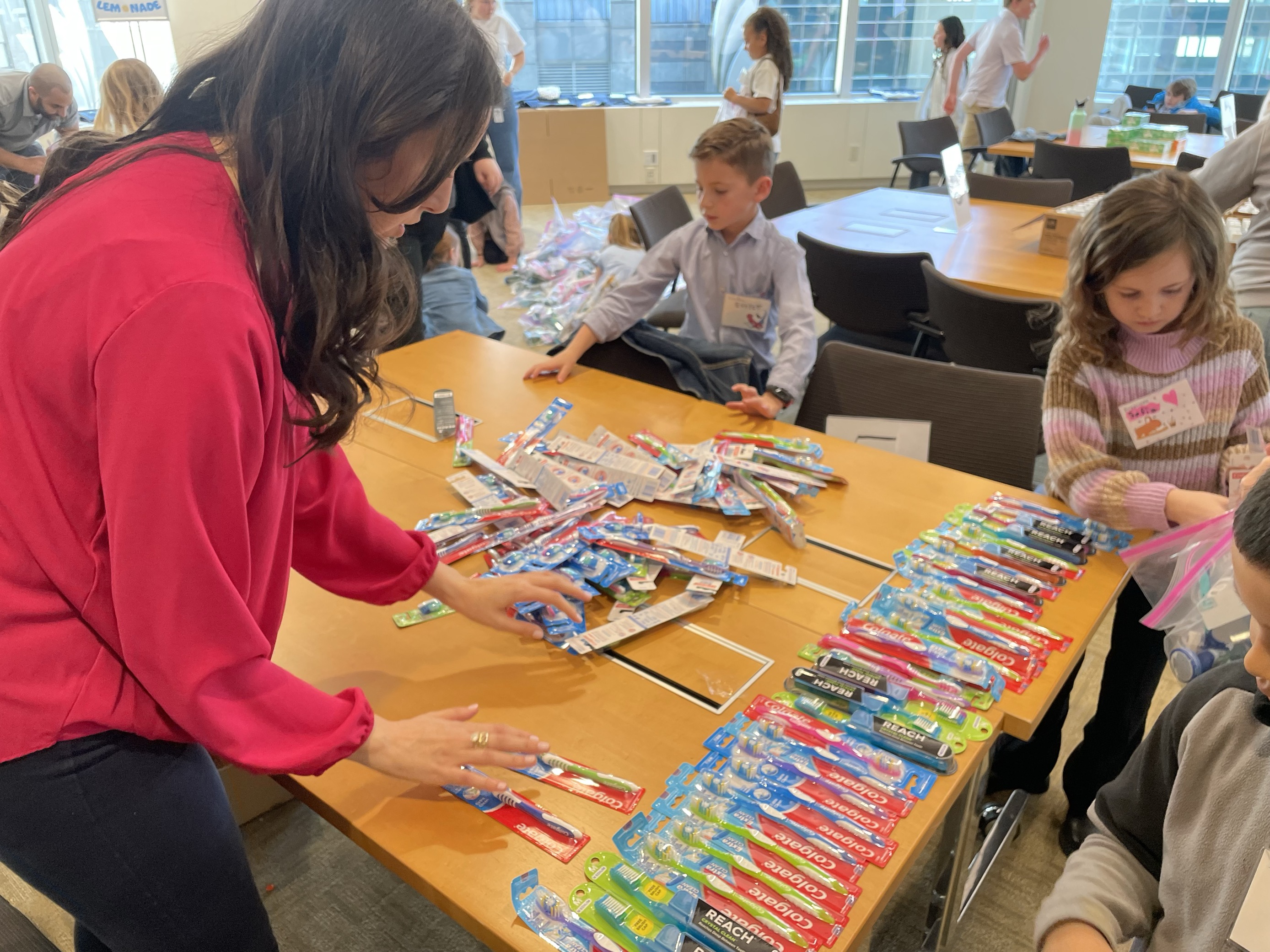 Two children packing toiletries on a volunteer project